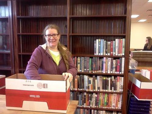 Robin B. is packing up the fiction books to get ready for the move back to the library, November 2013.