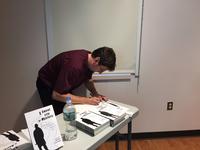 Steven Michaels signs books at the Art of Self-Publishing program. June 29, 2017.