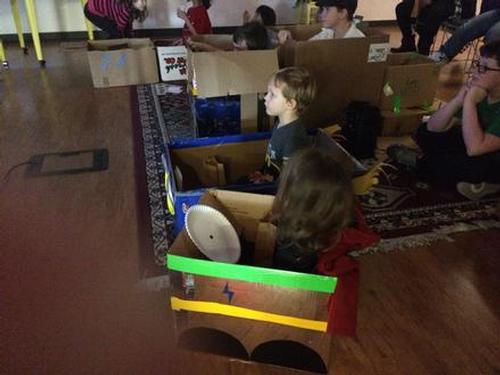 Children made cardboard box cars and watched Cars 3.