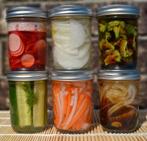 Fermented veggies in six glass jars.