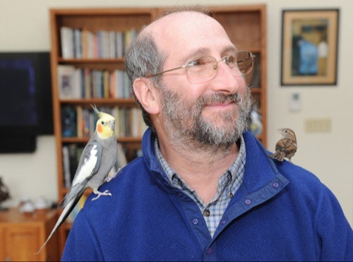 Richie Davis with two birds one on each shoulder.