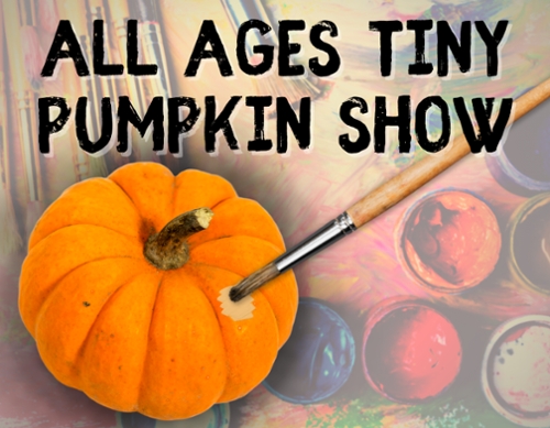 Tiny pumpkin with a paint brush painting a spot on it.