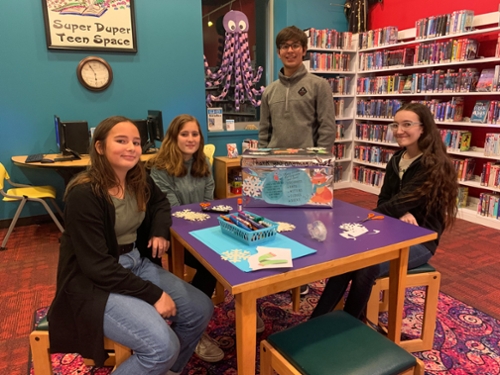 Teenagers decorating the scarf box.