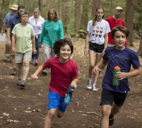Kids running on a trail having fun.